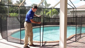 Pool Compliance Gold Coast inspector measuring glass fence