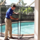 Pool Compliance Gold Coast inspector measuring glass fence