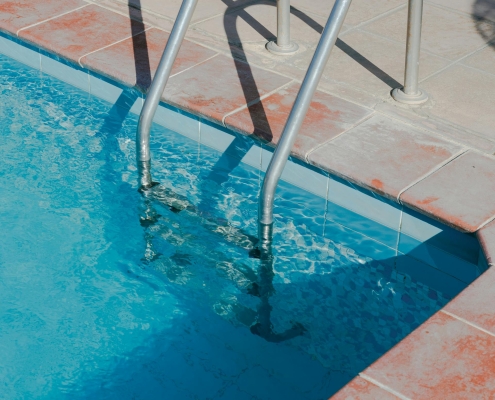 The image shows a ladder as one of the primary climbable objects in a pool